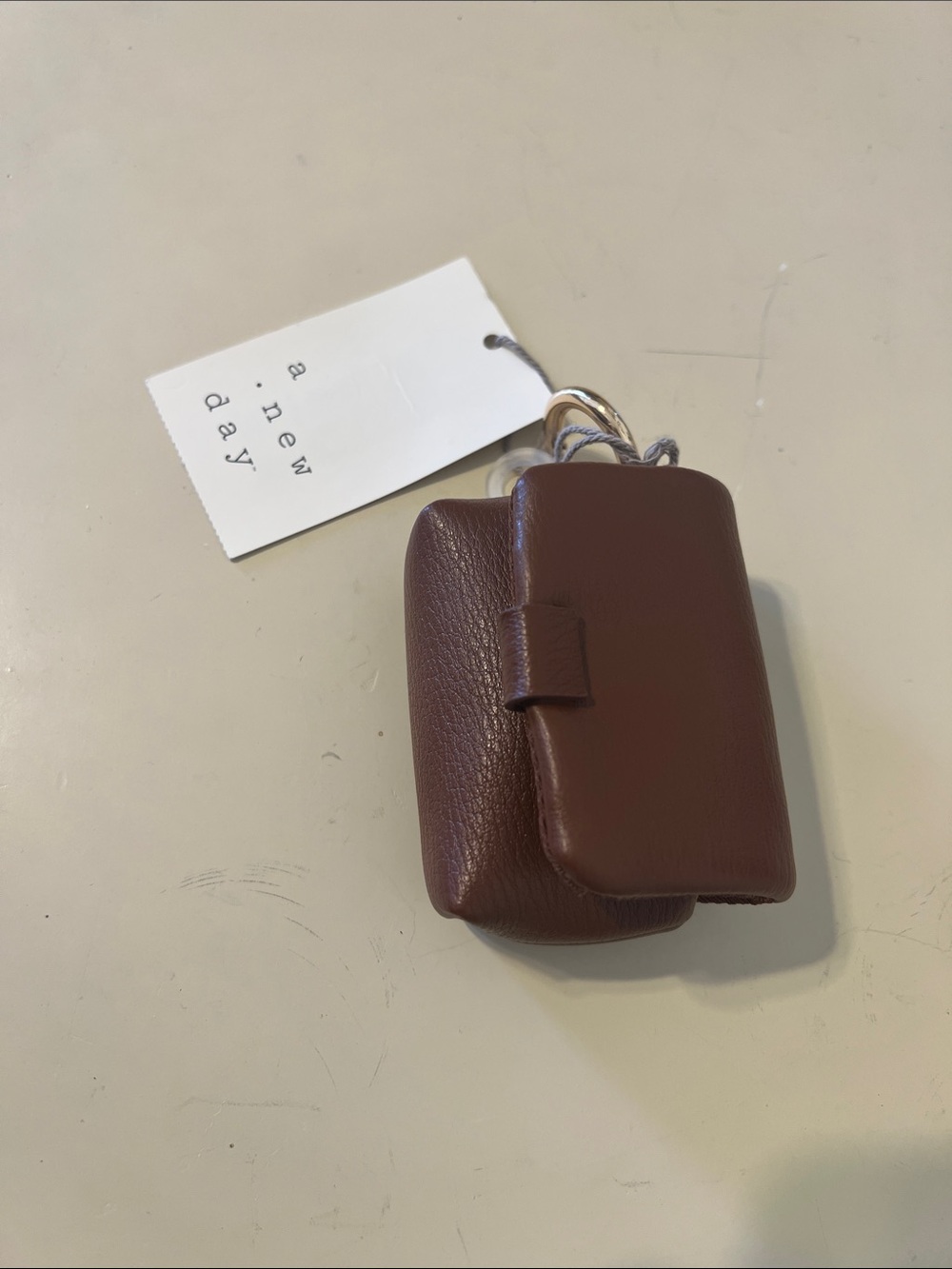 a new day Brown airpod case with ring